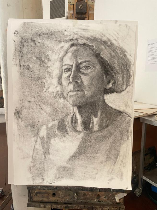 A charcoal portrait drawing of a lady