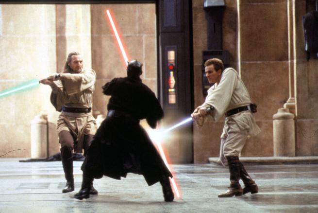 Two white-cloaked Jedi fight duel with a black-cloaked Sith 