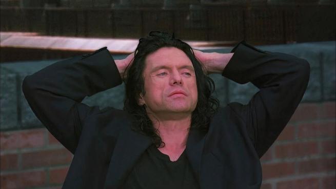 A still from The Room featuring Johnny played by Tommy Wiseau.