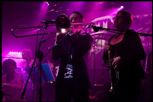 Salsa Como Loco band picture in concert featuring trombone and trumpet players
