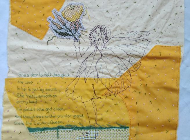 A textile piece with words stitched on