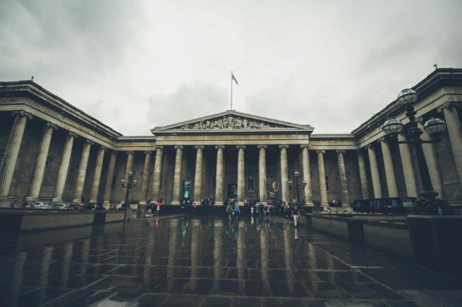 Photograph of the British Museum entrance on a grey rainy day.