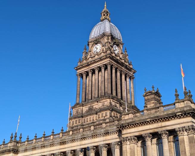 A grand building with a prominent clock tower, a symbol of architectural beauty