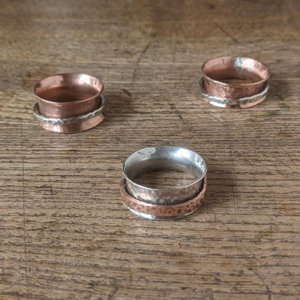three spinning rings made of silver and copper