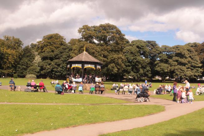 A band performing in the bandstand at Horsforth Hall Park. 