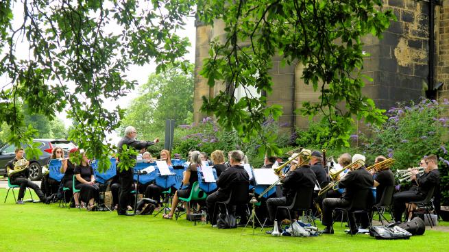 Wakefield Orchestral Wind perform in a park. 