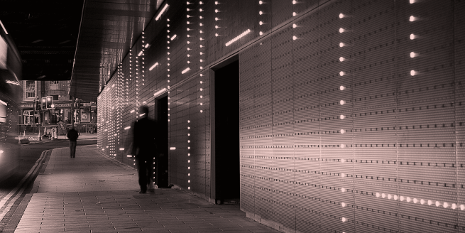 Picture of light and sound installation at Neville Street - rows of lights in a tunnel and darkened doorways