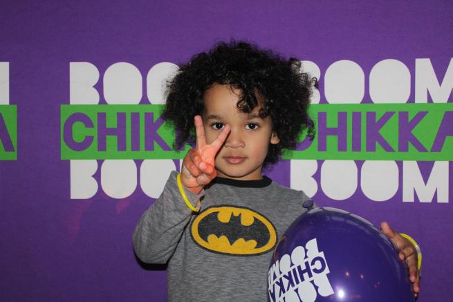 child with Boomchikkaboom balloon