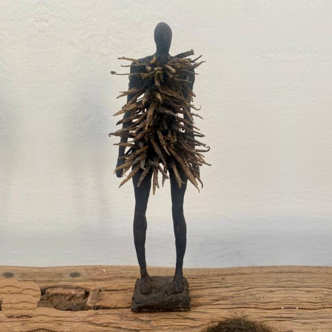 A human-like figure pierced by spikes