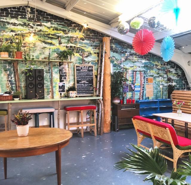 a warm image of the upstairs cafe space at open source arts, scene of where the dance will be held