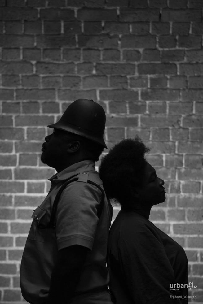 A man and a woman backing each other.