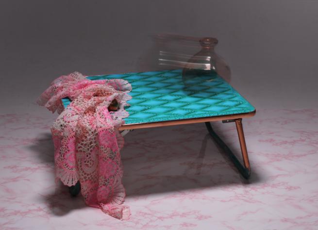 A photo of a tiny green table