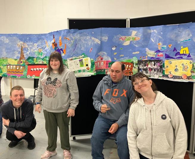 Pyramid's Next Step group stand in front of their artwork