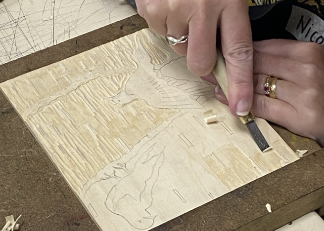 An image of a bird being carved into a plywood block ready to be printed from.