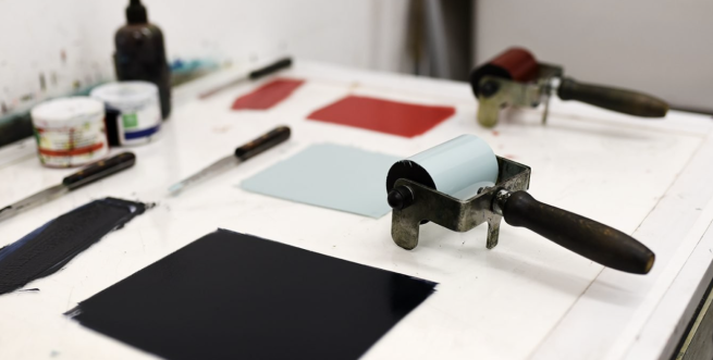 Ink rollers and ink ready to roll out with, in light blue and red.