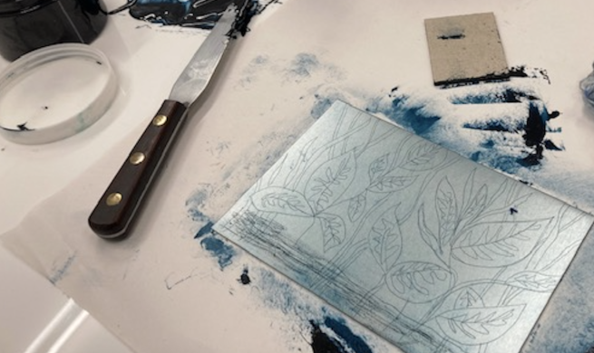 An etched zinc plate with a design of leaves redy to be printed from