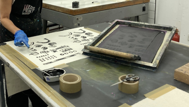 Abstract black and white imagery being screen printed onto a textiles