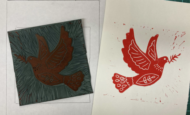 A red image of a dove being that has been printed from the lino alongside it.