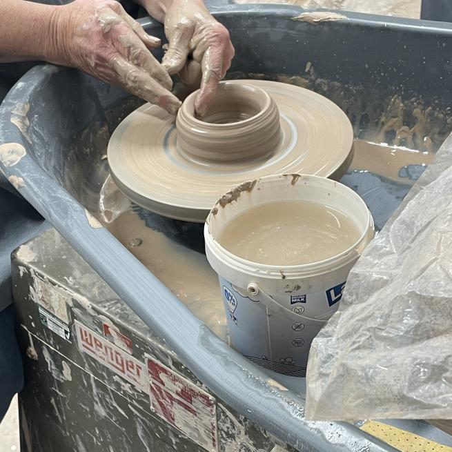To hand forming a pot on the wheel