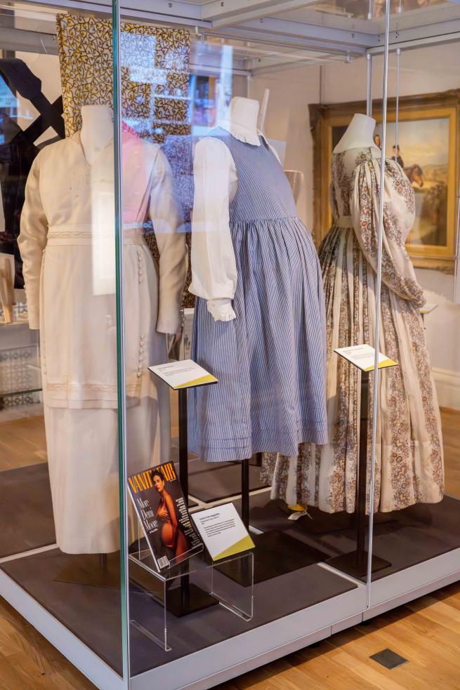 An exhibition case of historic maternity costumes