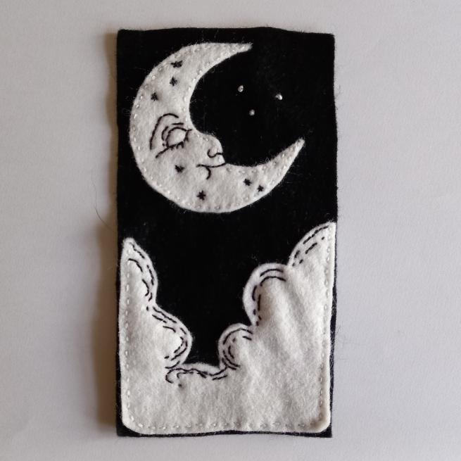 A black and white patch with a moon and clouds