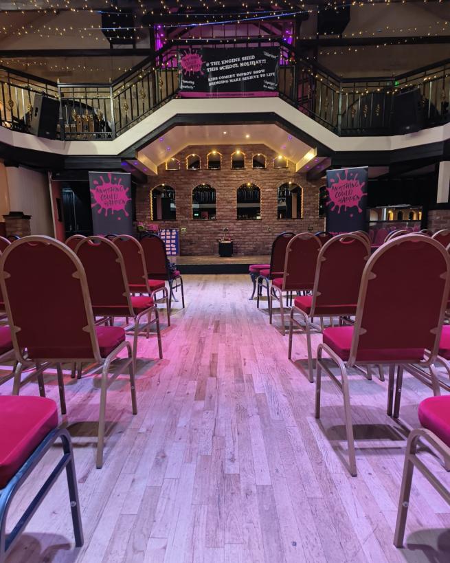 An empty stage. Empty chairs waiting for the fun to start