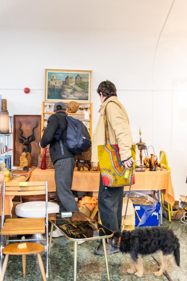 Image of people shopping at a vintage flea market stall.