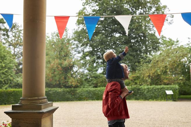 image of a child reaching for bunting