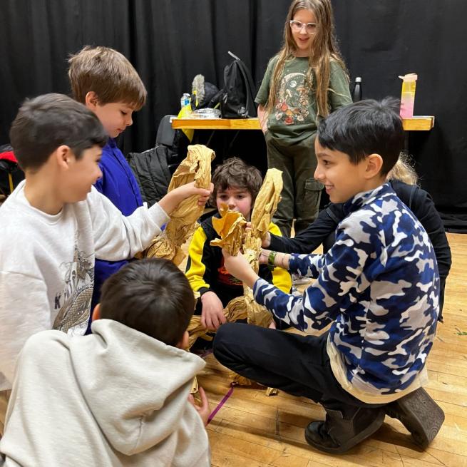A group of children designing a play in the studio at Leeds Grand Theatre.