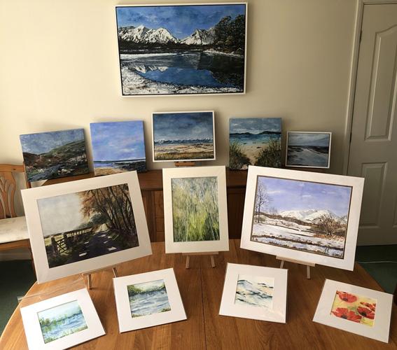 Display of paintings by Jenny Sharpe, landscapes and seascapes.
