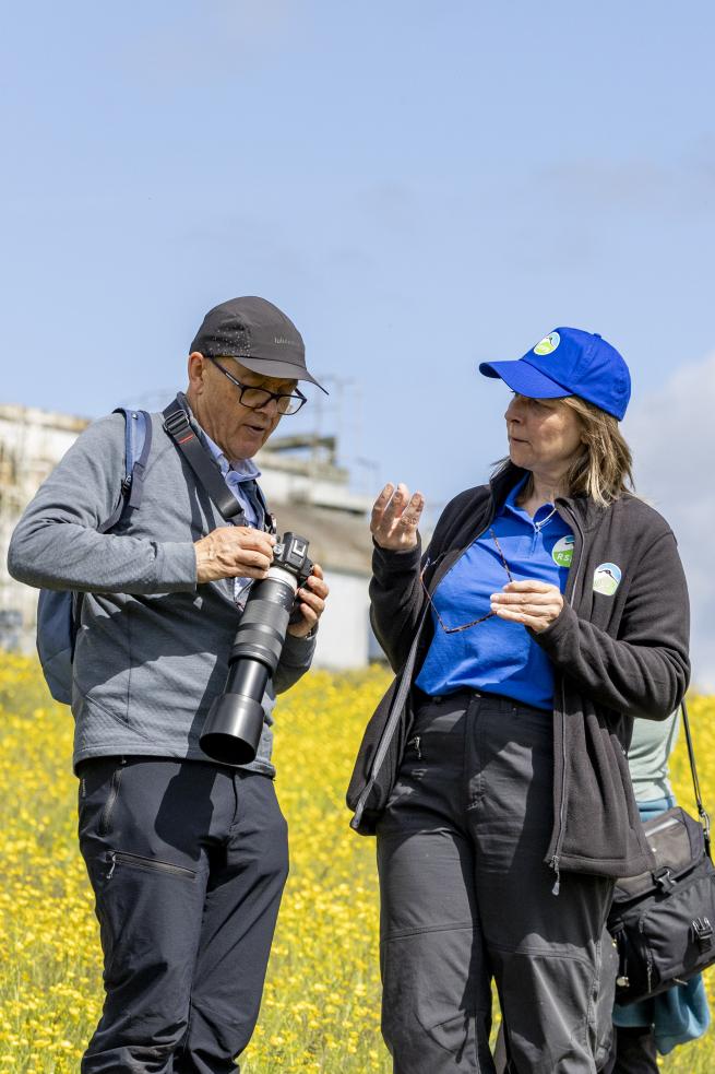 A visitor and the RSPB event lead discussing camera settings on a Specialised Beginner's Photography Workshop