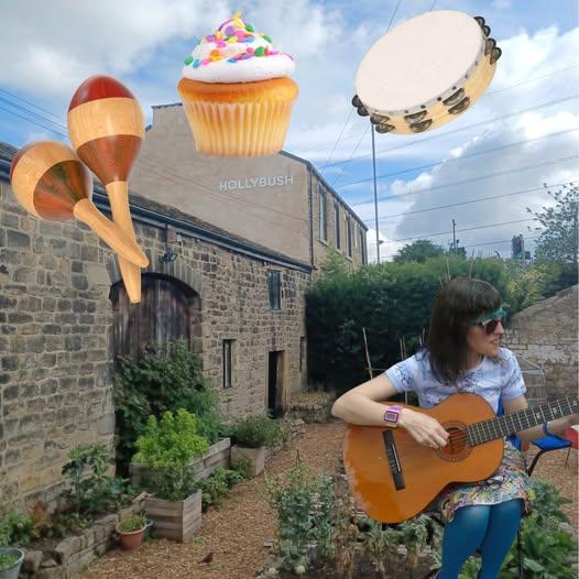 Nicky singing in front of Hollybush with flying, percussion and cake