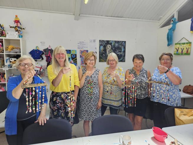 An image showing the adults group who made beaded windchimes