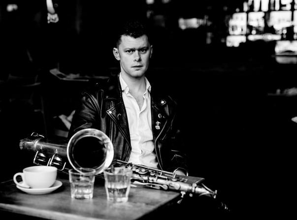 Ben Powling seated with saxophone 