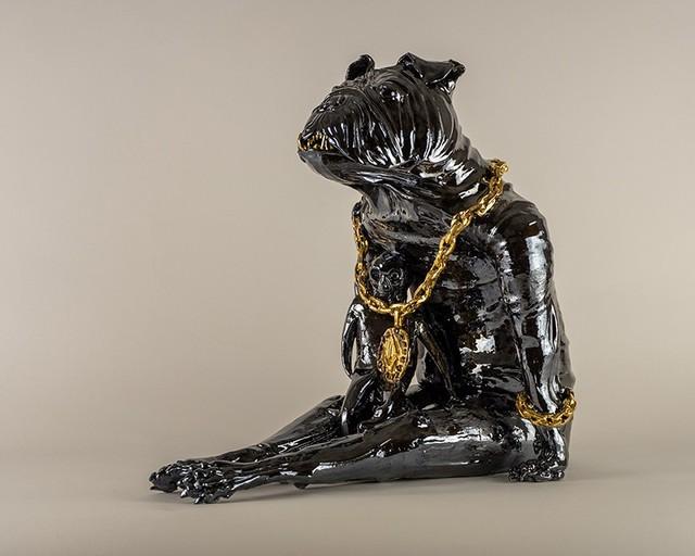 Ceramic figure of sitting hybrid human/dog with large necklace