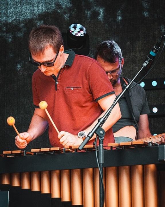 John settle playing a vibraphone 