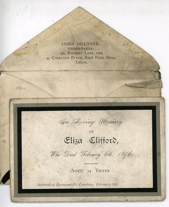 An image of a Victorian mourning card dedicated to Eliza Clifford, buried in Burmantofts Cemetery, who passed away Feb 6 1896 and was interred 2 days later. The card is a faded white surrounded by a black border. Behind it is an envelope which contained the card, and it has the address JAMES HILLYARD, undertaker, 34 Ellerby Lane, and 4 Charlton Place, East Park Road, Leeds. 