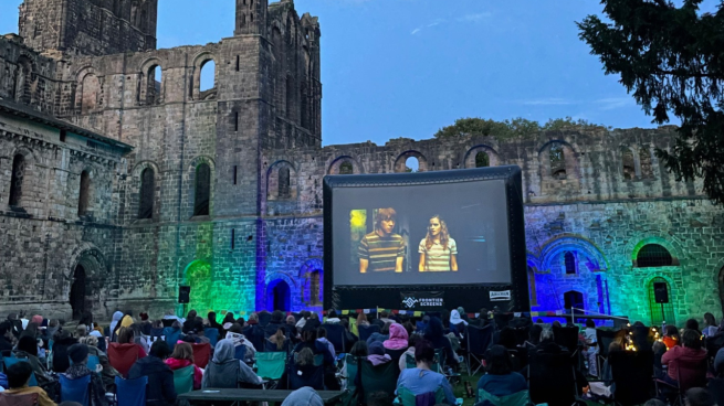 Outdoor cinema screen inside the walls of Kirkstall Abbey