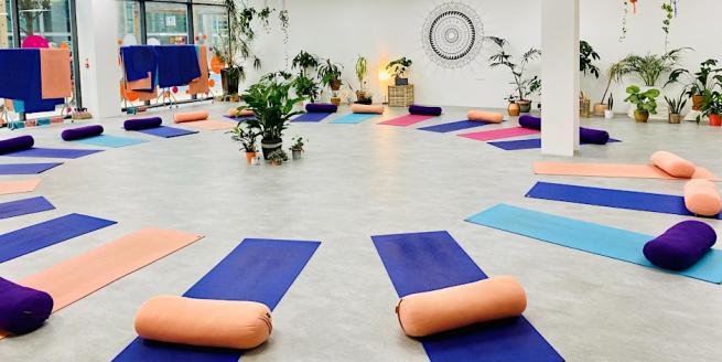 Yoga Hero studio with mats and bolsters laid out in a circle