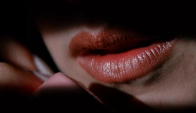 Still from Lost Highway, close up of lips speaking on a phone 