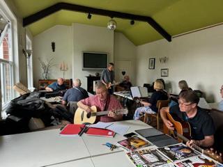 rivers MEET Strummers in a building. They have stringed instruments
