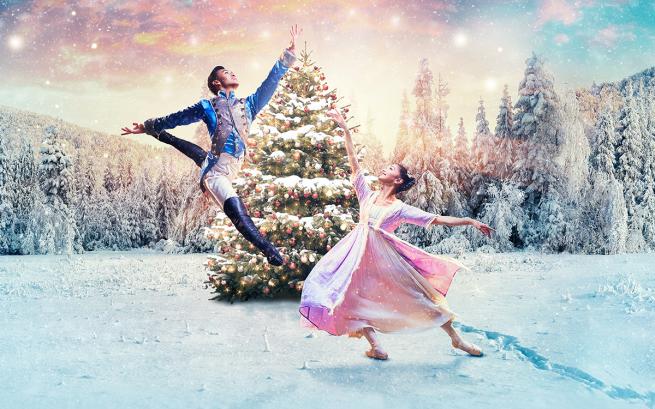Clara and the Nutcracker Prince pose in front of a Christmas tree surrounded by a winter wonderland.