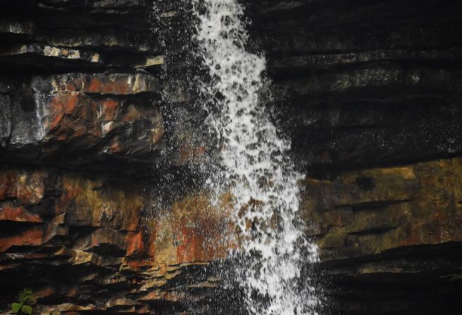 Picture of a zoomed in waterfall with rocky background