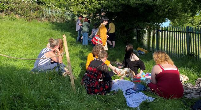 a group of young people on a grassy verge