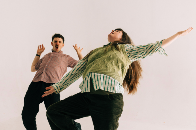 Two figures dancing expressively.
