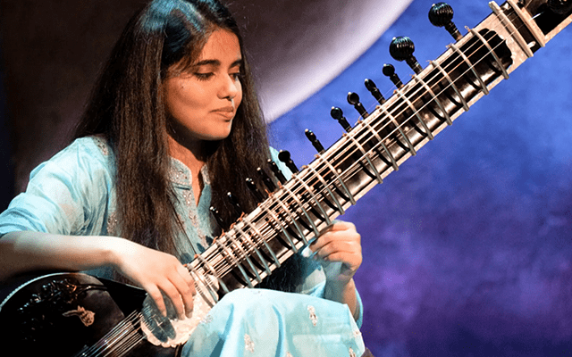 A picture of Sansrkit Wahane playing the sitar