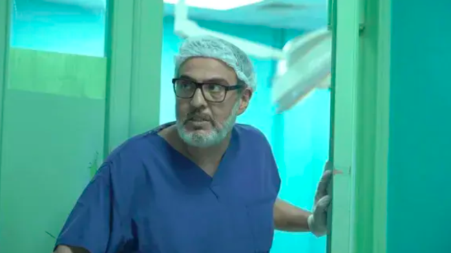 Film still from A State of Passion, of Dr. Ghassan Abu Sittah in surgical blue gown