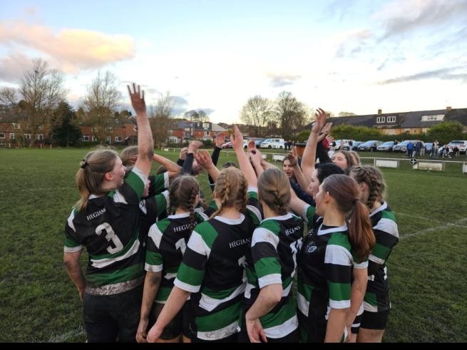 Girls celebrating rugby win.