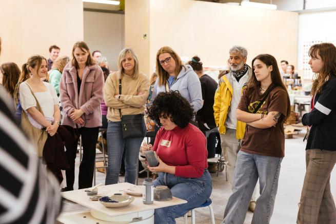 Pottery demonstration at Sunken Studio with visitors watching ceramic decorating process