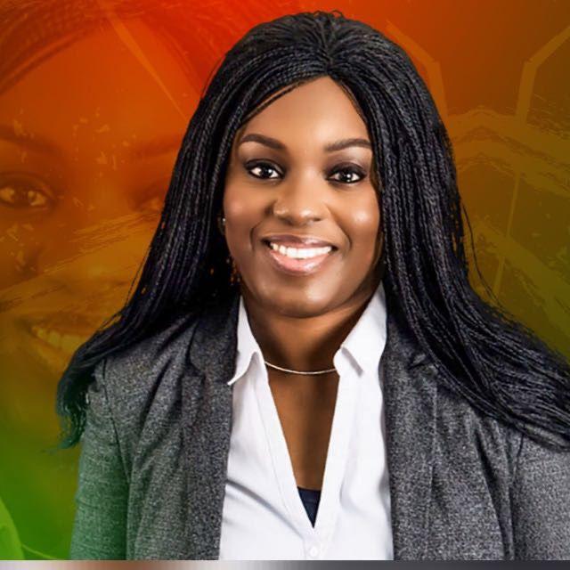 Picture of one of the speakers with a Grey suit and an inner white shirt and black braided hair. Brown skinned with a smile